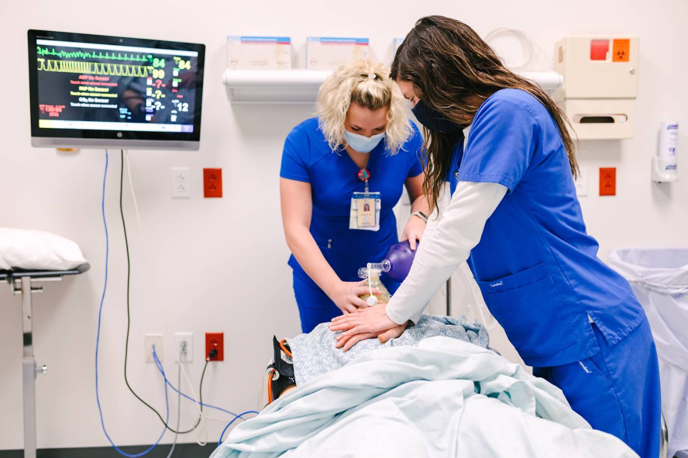 Nursing students perform CPR in lab