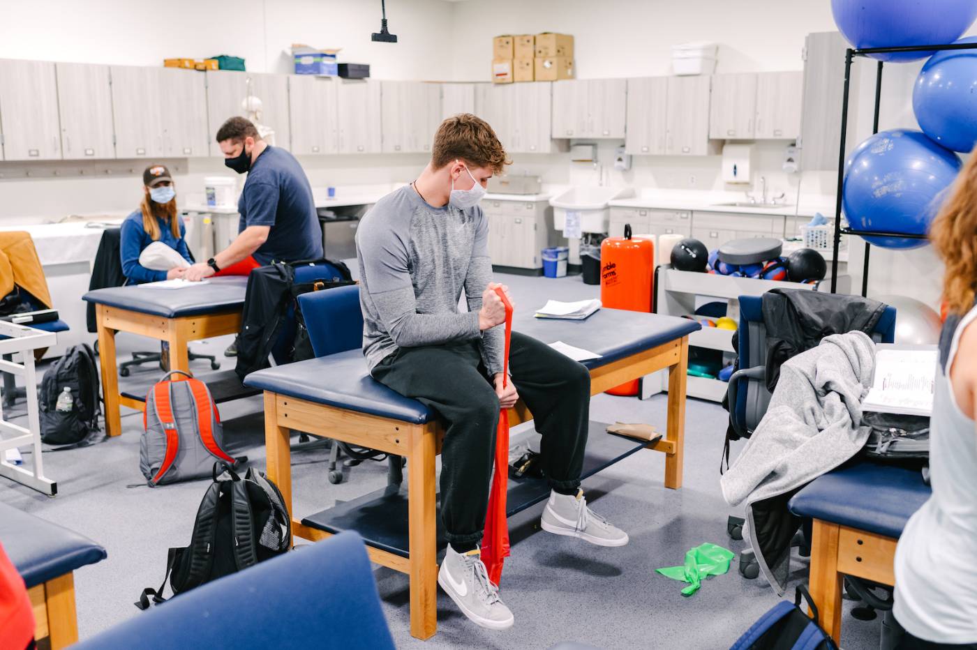 Student practicing with exercise band in lab